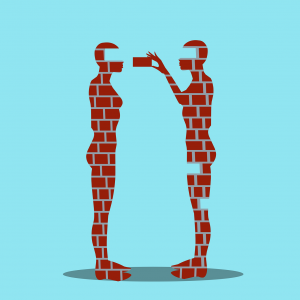 Zwei Menschen, aus Backsteinen gebaut, stehen sich gegenüber. Eine Person nimmt aus der anderen einzelne Steine heraus - Coaching Koblenz